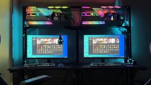 A dual-monitor workstation with a mechanical keyboard, a mouse, and a chair. - Zhongxiangshun Tianyuan Business Hotel (Zhongxiang)