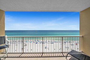 A balcony with a view of a beach. - FREE Golf&Perks! Majestic Tower 1-910, 5 Pools, 3 Hot Tubs, Theater & Tennis! (Panama City Beach)