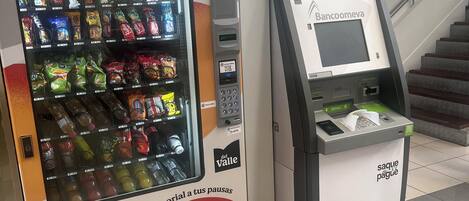 A vending machine and a self-service banking kiosk in a public area.