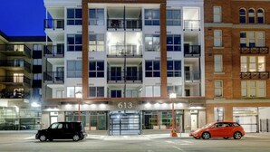 Un edificio de varios pisos con el nombre "CITYZEN" en la fachada, que cuenta con una entrada a nivel de calle con puerta de vidrio y el número "613" mostrado arriba.