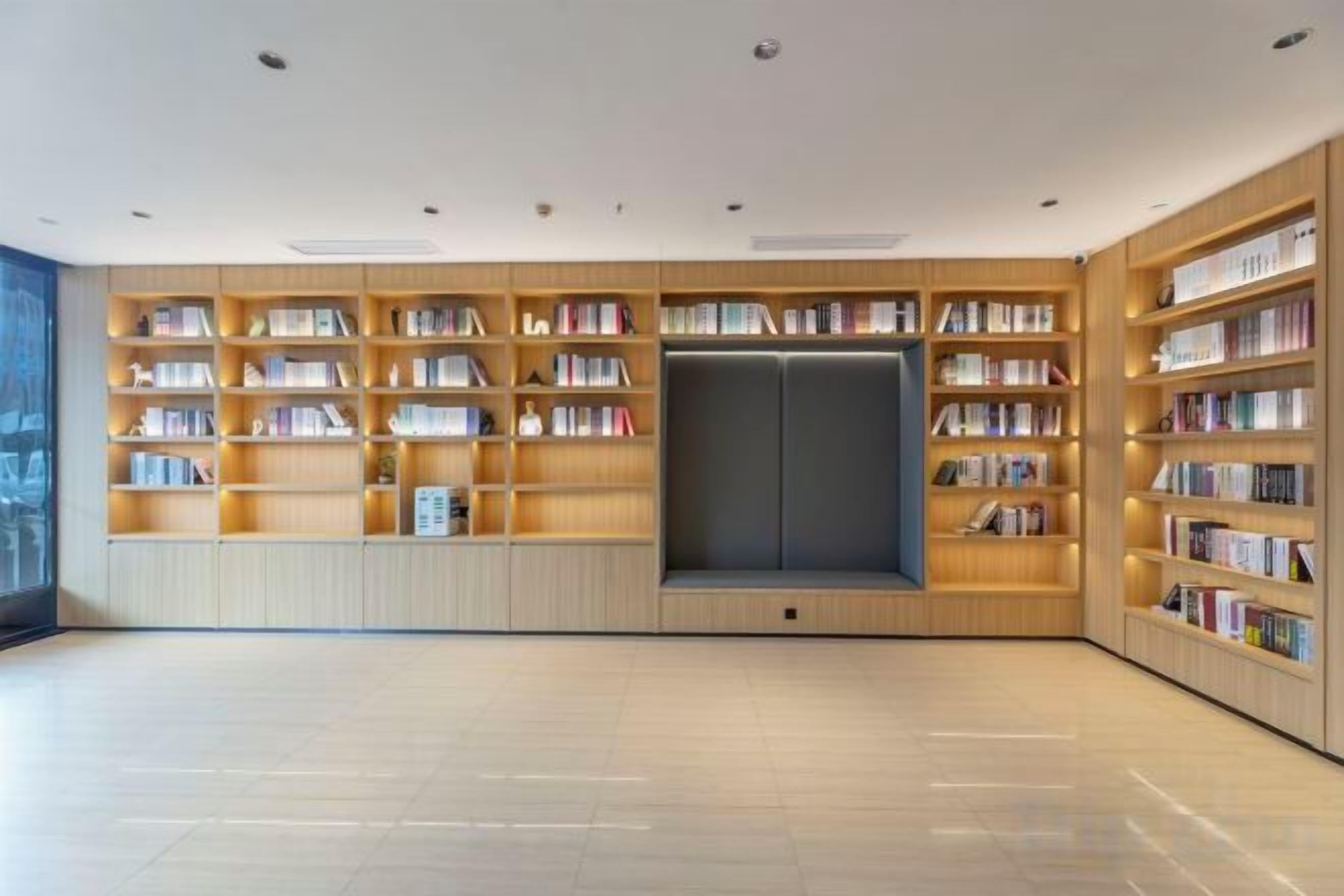 A library with multiple wooden bookshelves and a central seating area.