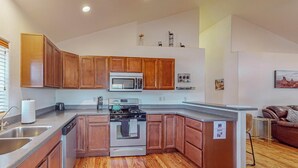 A modern kitchen with wooden cabinets, stainless steel appliances, and a wooden floor. - Fantastic 3bd/2ba in N. Valley, Garage, near i40 (Albuquerque)