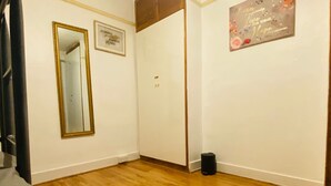 A room with wooden flooring, a large mirror, a door, and a motivational quote on the wall. - Cosy Double room - 2 guests -Close to central London-5minsHarrow and Wealdstone  (Harrow)