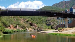 A bridge over a river with a clear sky. - Hadley House Key to Villas (Viddalba)