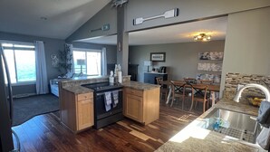 A spacious kitchen with wooden cabinets, a granite countertop, and a built-in oven. - Lake Life is for Everyone  (Maple Lake)