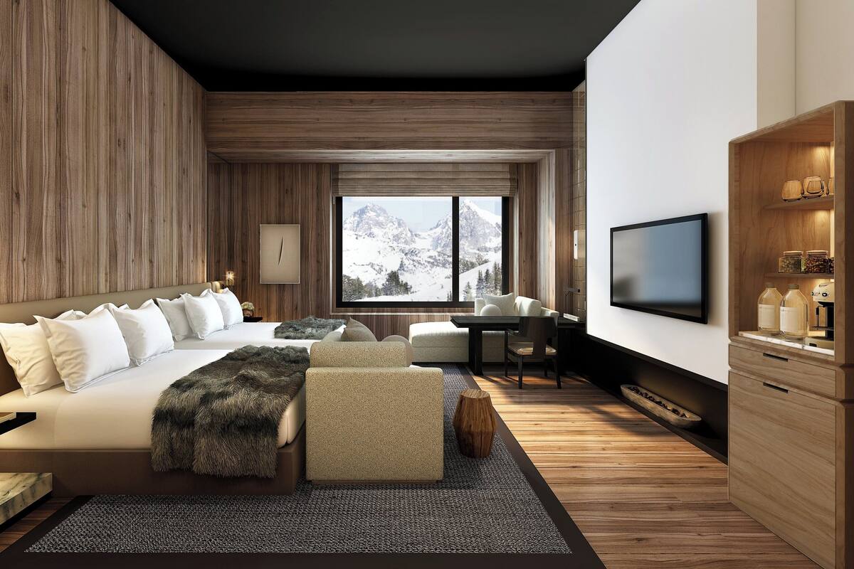 Une chambre moderne avec un grand lit, un bureau et un téléviseur.