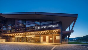 A modern building with a sign reading "Intercontinental." It features a prominent entrance with glass doors and a covered walkway. - Intercontinental Chongli by IHG (Zhangjiakou)
