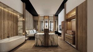 A modern hotel room with a marble bathroom, wooden paneling, a central seating area, and a large window offering a mountain view. - Intercontinental Chongli by IHG (Zhangjiakou)