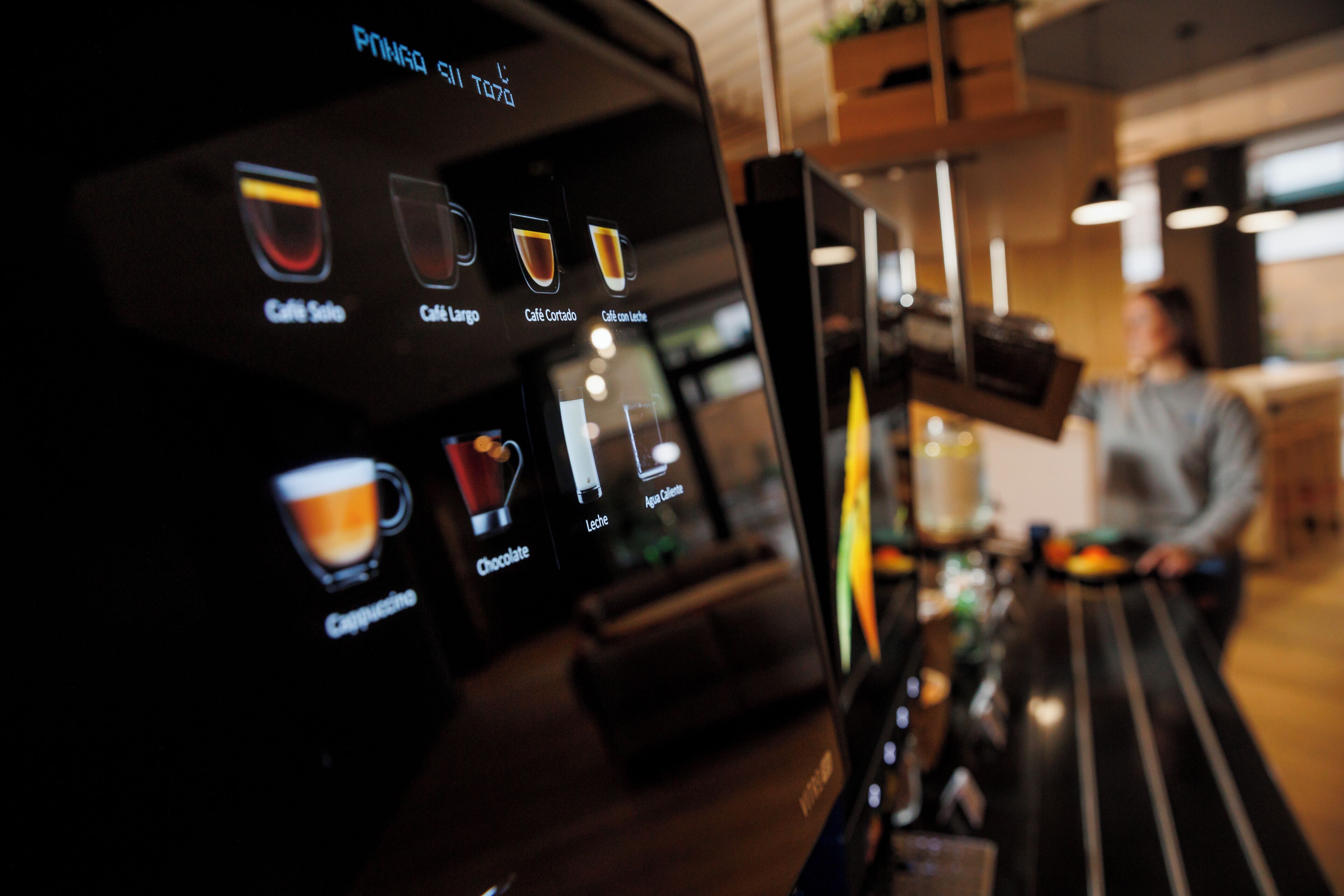 A coffee machine with various drink options displayed.