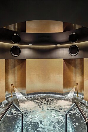 A spa area with a hot tub, water jets, and a modern design.
