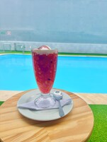 Un postre sobre una mesa de madera con una piscina al fondo.