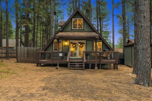 A cabin with a front porch, a chimney, and a wreath on the door. - Blue Canyon (Flagstaff)
