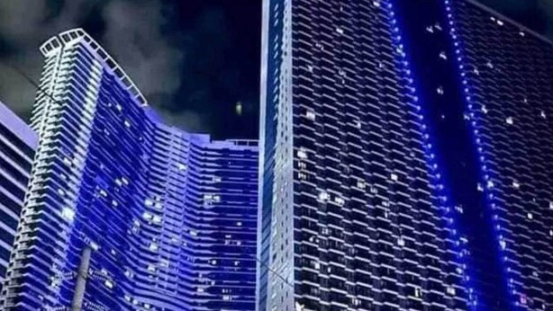 A high-rise building with a curved facade, multiple floors, and a central vertical structure. - 1 Bedroom with Balcony Condo Apartment in Makati City (Makati)