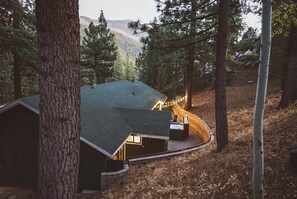 Une cabane dotée d’un toit incurvé, d’un bain à remous et d’une terrasse.