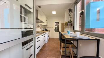 Fridge, microwave, coffee/tea maker, cookware/dishes/utensils