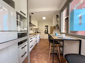 Fridge, microwave, coffee/tea maker, cookware/dishes/utensils