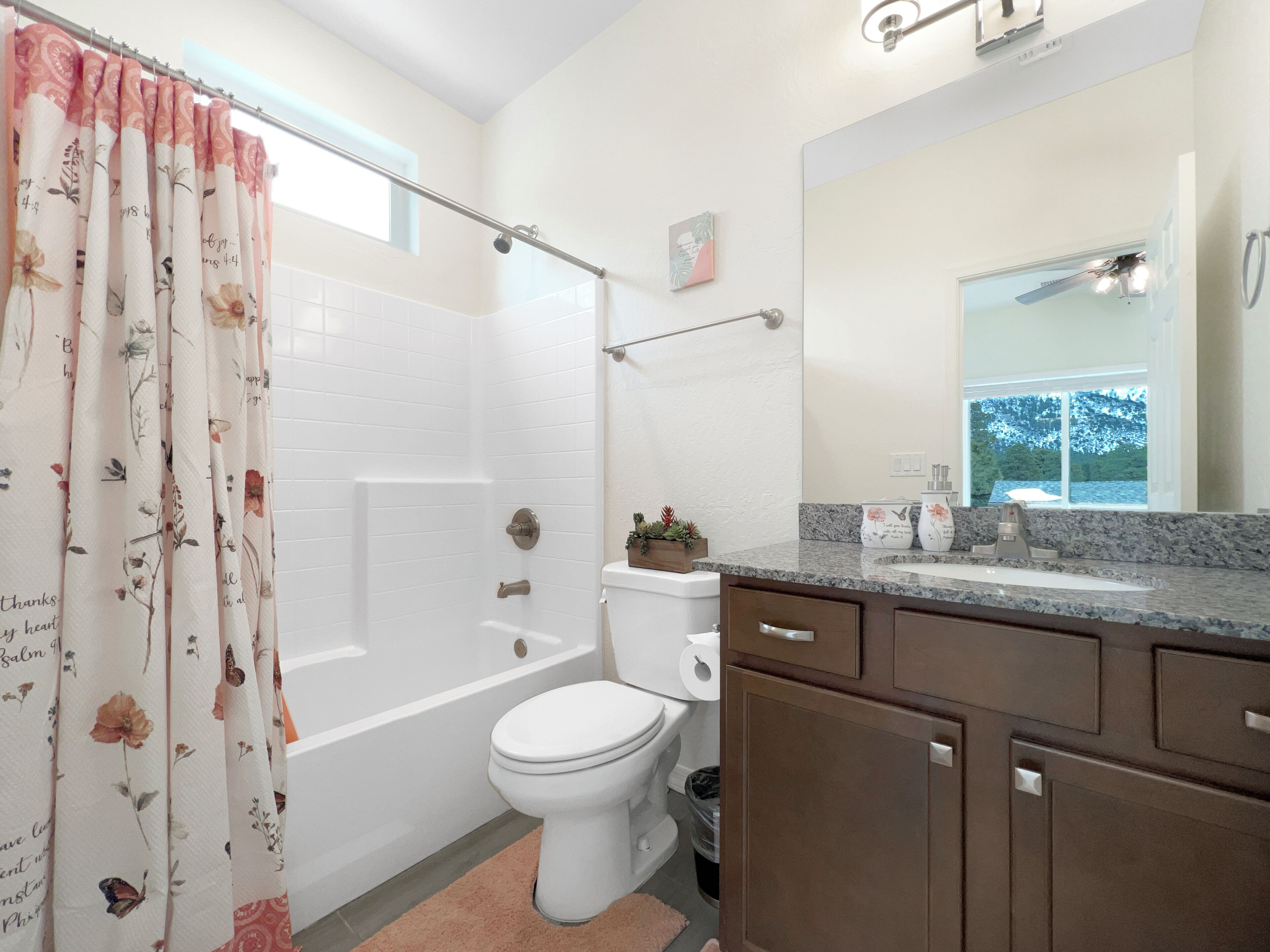 A bathroom with a shower, toilet, and sink.