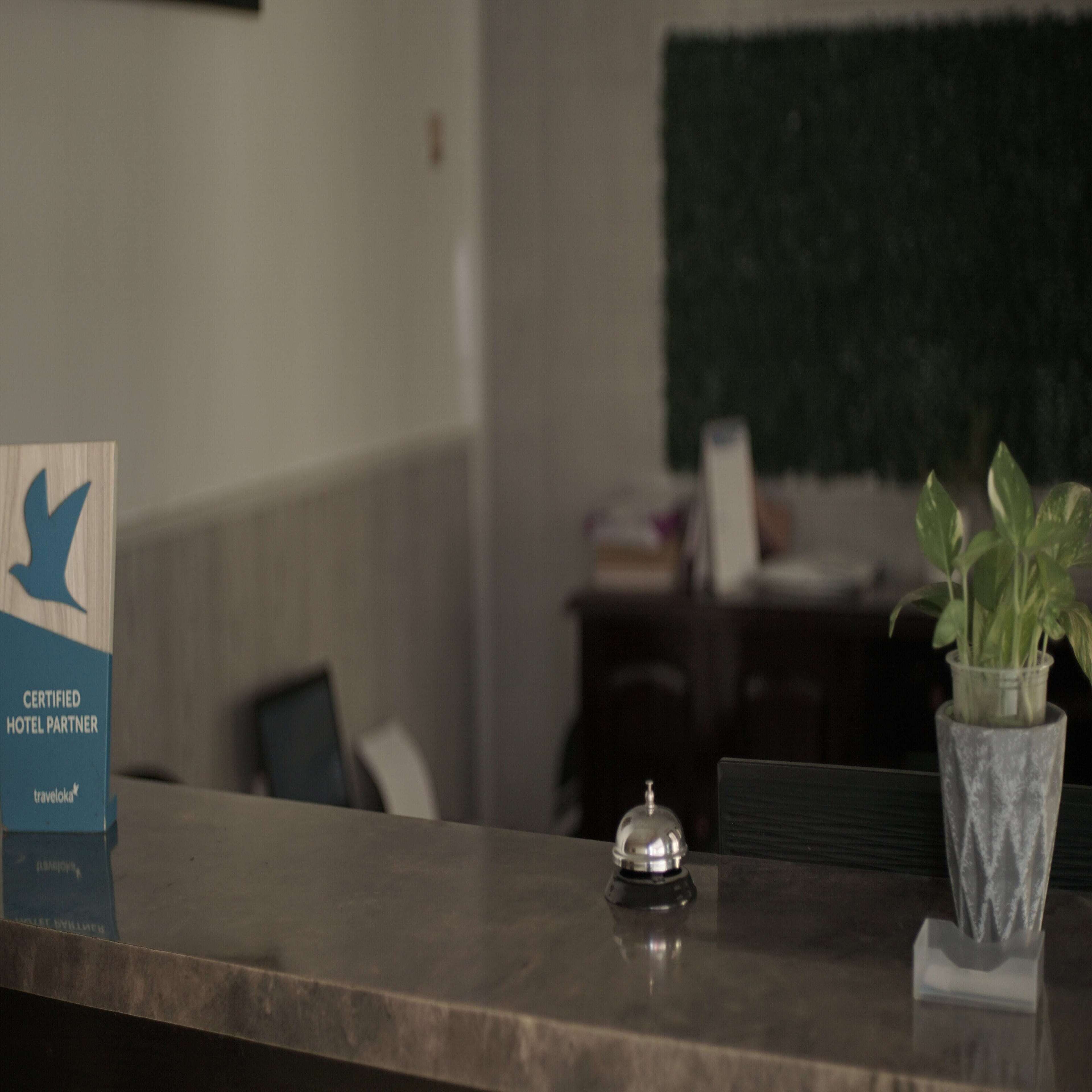 A reception desk with a sign indicating it is a certified hotel partner.