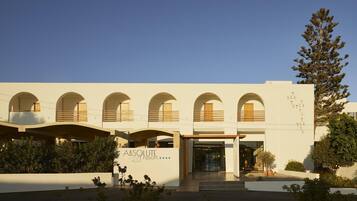 A modern building with a series of arched windows and a sign that reads 'ABSOLUTE resort'.