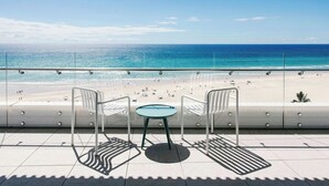 A balcony with a glass railing overlooking a beach. - Kirra Point Holiday Apartments (Coolangatta)