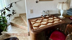 A room with a dining table, a chair, a lamp, a painting on the wall, and a staircase. - Apartment 'Fuldawiesen' with Balcony and Wi-Fi (Schlitz)