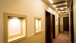 A hallway with recessed lighting and wooden doors. - Hongsi Hotel (Kathmandu)