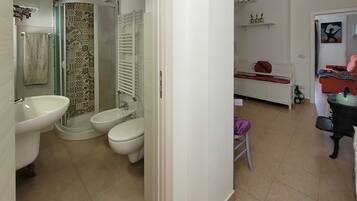 Une salle de bain équipée d’un lavabo, d’un bidet et de toilettes.