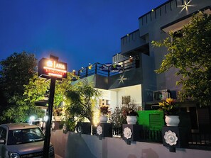 Welcome to this charming home stay, featuring a balcony with string lights and a modern architectural design.