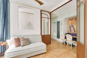 Relax in a clean, minimalist space with a sofa, table, and chair.