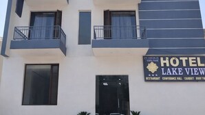 Un hotel moderno con fachada plana, varios balcones y un letrero que indica que es Lake View Hotel.