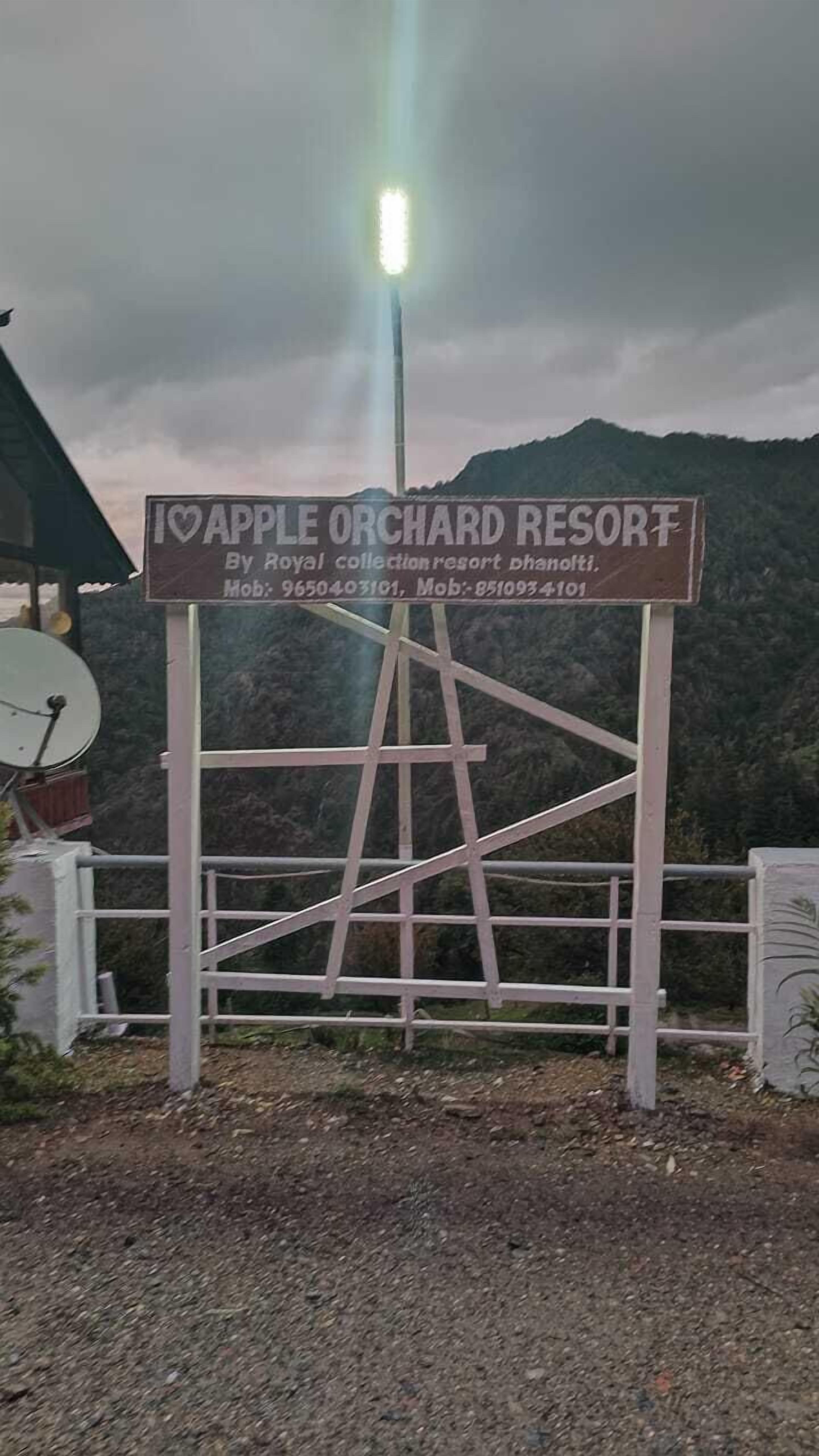 A sign for Apple Orchard Resort, including contact numbers.