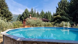 A swimming pool with stone walls, surrounded by trees and a mountain in the background. - GuestHost - Wonderful 140 sqm apartment, perfect for 7 people, located on the first floor of an old renovated semi-detached house surrounded by greenery (stairs to access it).The apartment is located in Borgo a Mozzano, a picturesque village immersed in  (Borgo a Mozzano)