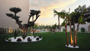 A well-maintained garden with various trees and a pool area. - VENZI AYAYORGI ADULT ONLY +15 (Cesme)