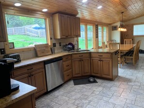 Enjoy cooking in this well-equipped kitchen with a large island, dishwasher, and sink.