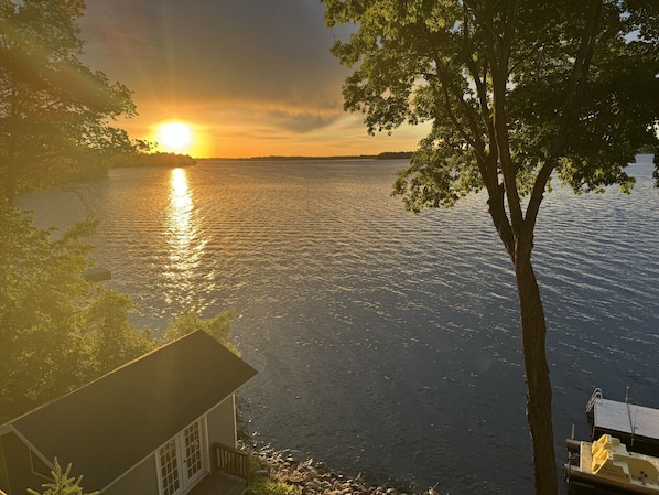 A lakeside view with a house and dock.