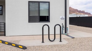 A building with a window, a sign reading "WASHING STATION," and a hose connected to a water source. - Vizcaya #7 - Moab's Newest Luxury Rental (Moab)