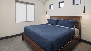 A bedroom with a large bed, a window, and a ceiling fan. - Vizcaya #12 - Moab's Newest Luxury Rental (Moab)