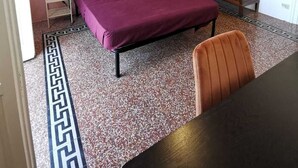 A bedroom with a bed, a wardrobe, a chair, a lamp, and a painting on the wall. - 2 Bedroom Apartment in Palermo (Palermo)