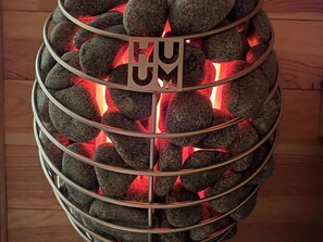 A spherical structure with a metallic frame and a glowing red interior, possibly a decorative piece or a light fixture.