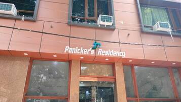 A building with the sign "Panickers Residency" above the entrance.