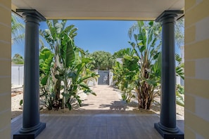 A covered outdoor area with columns, a pathway, and banana plants. - Exceptionally spacious 5 bed villa with swimming pool, snooker table - 155319/AL (Faro)