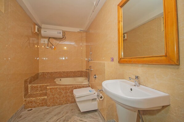 A bathroom with a bathtub, a sink, and a toilet.