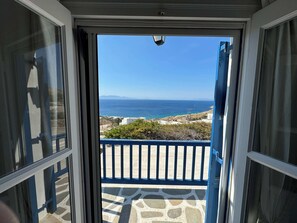 Step out onto the balcony and take in the breathtaking views of the sea and distant land.