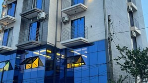 A modern hotel building with multiple balconies, large windows, and a prominent 'SMART HOTEL' sign. - SMART HOTEL (Douala)
