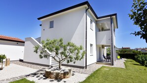 A modern two-story house with a white exterior, a stone pathway leading to the entrance, and a small tree in the front yard. - Villa Mares 1 with shared pool in a quiet village near Umag (Cepljani)