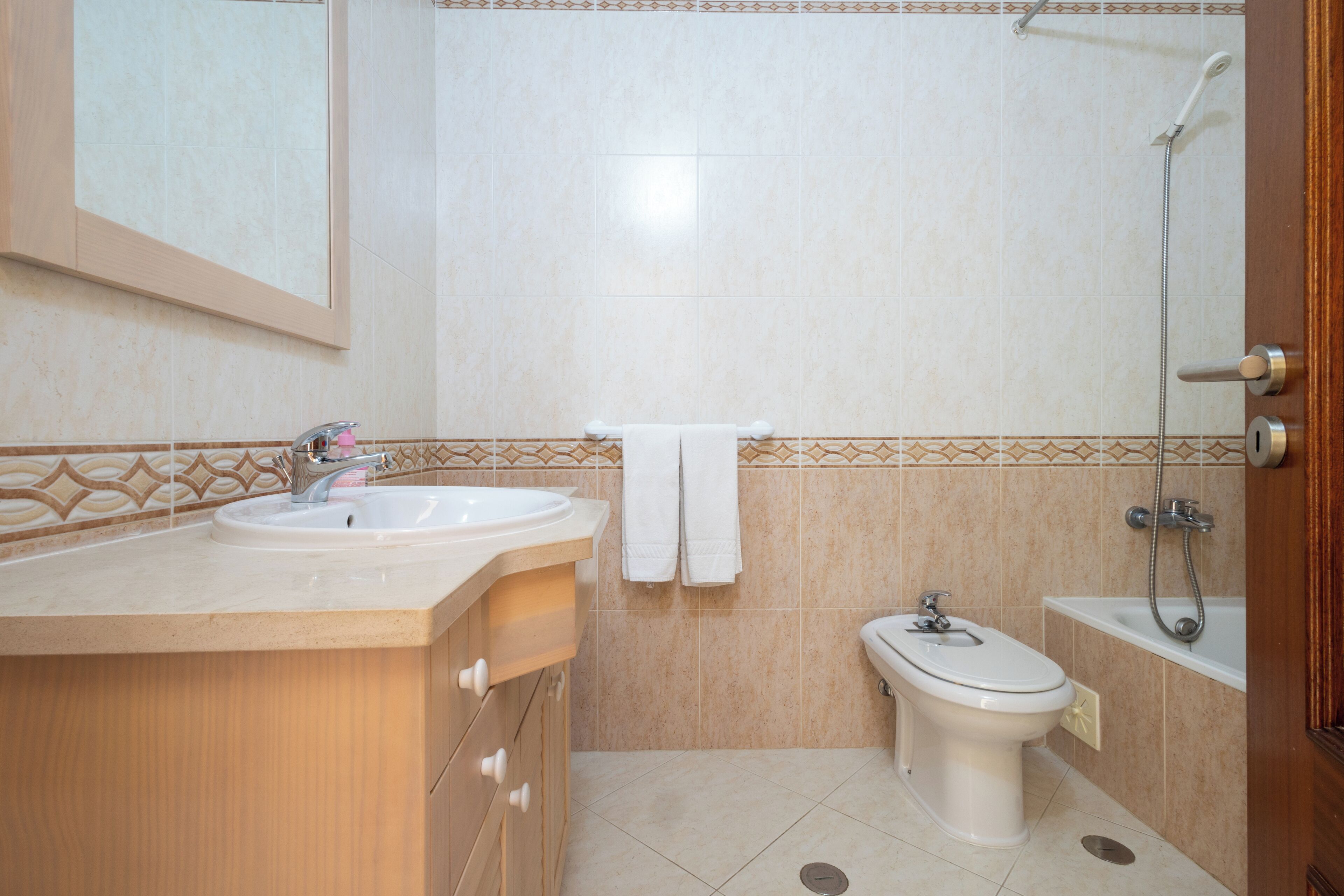 A bathroom with a sink, toilet, and shower.