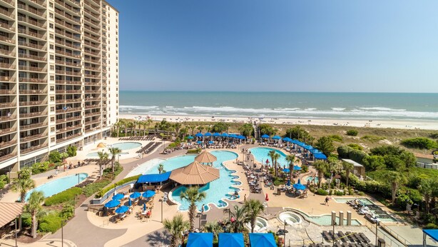 A resort with multiple swimming pools, a beach view, and a large hotel building. - Oceanfront Oasis: 2BR 2BA Condo with Stunning Views (North Myrtle Beach)