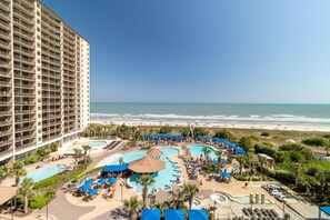 A resort with multiple swimming pools, a beach view, and a large hotel building. - Oceanfront Oasis: 2BR 2BA Condo with Stunning Views (North Myrtle Beach)