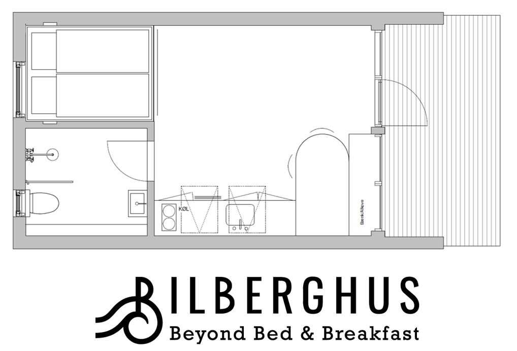 A hotel floor plan with a bathroom, kitchenette, and a large living area.