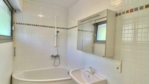 A bathroom with a bathtub, a sink, and a toilet.